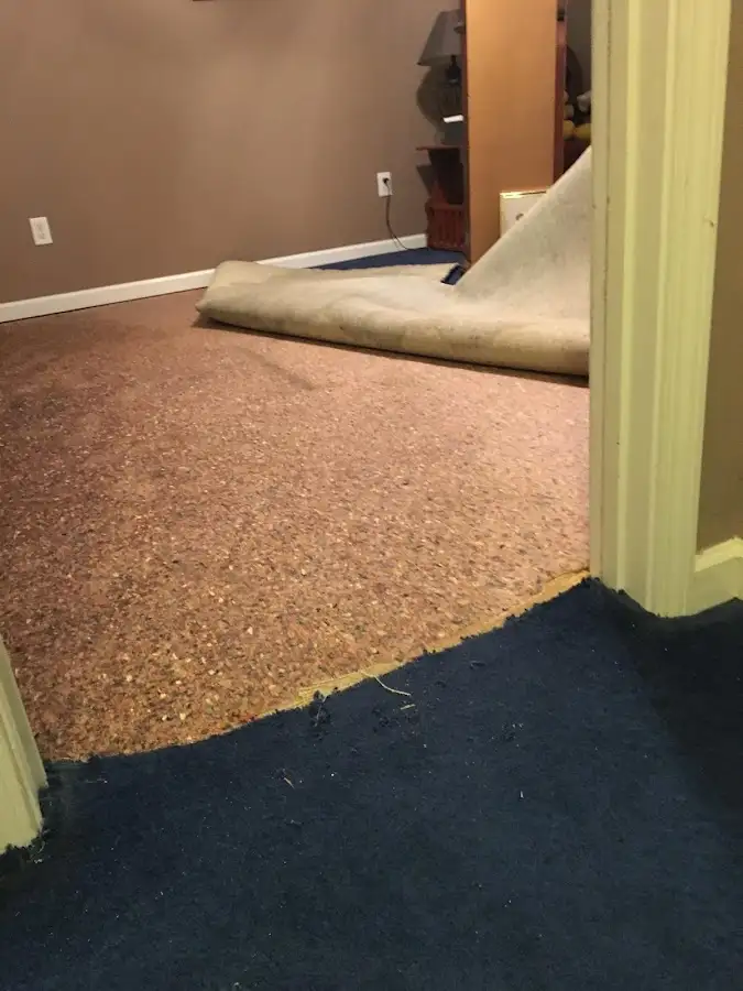 Carpet pad removal revealing water damage during Water Mitigation Services in Hood River